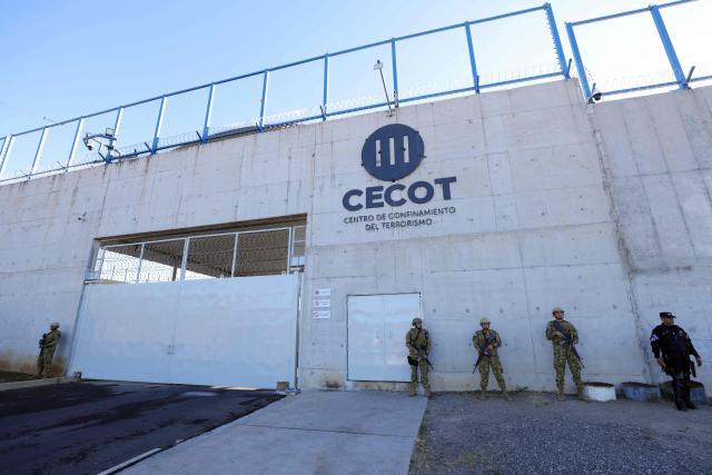 Military personnel stand guard before the arrival of Chile's president-elect Jose Antonio Kast at the Counter-Terrorism Confinement Center (CECOT) mega-prison, where hundreds of MS-13 and 18th Street gang members are being held, in Tecoluca, El Salvador, on January 29, 2026. The CECOT, the largest prison in Latin America and emblem of the war against gangs of the government of President Nayib Bukele, celebrates two years since it was inaugurated on February 1. (Photo by Oscar Rivera / AFP)