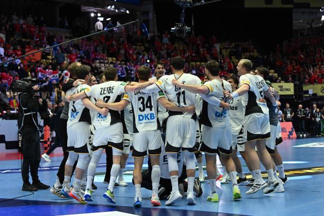 Germany's players celebrate after winning the men's EHF Euro 2026 semi-finals handball match Germany vs Croatia in Herning, Denmark, on January 30, 2026. (Photo by Jonathan Nackstrand / AFP)