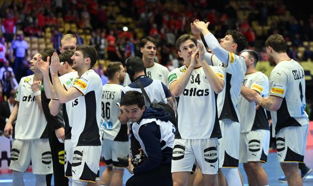 Germany's player celebrate after winning the men's EHF Euro 2026 semi-finals handball match Germany vs Croatia in Herning, Denmark, on January 30, 2026. (Photo by Jonathan Nackstrand / AFP)