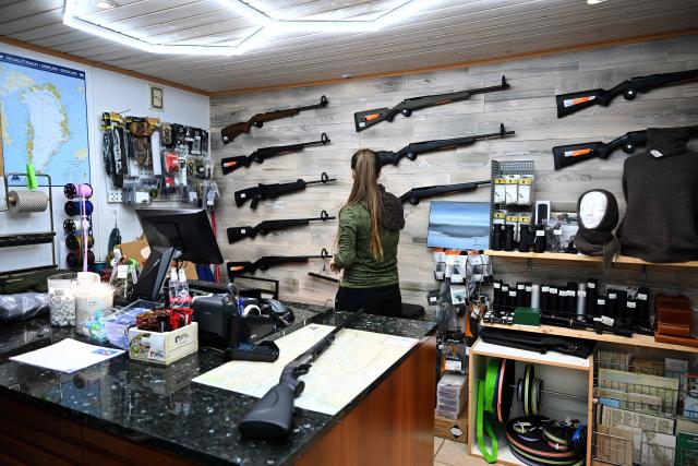The owner of a shop looks to hunting rifles of Sisimiut, Greenland on January 30, 2026. (Photo by Ina FASSBENDER / AFP)