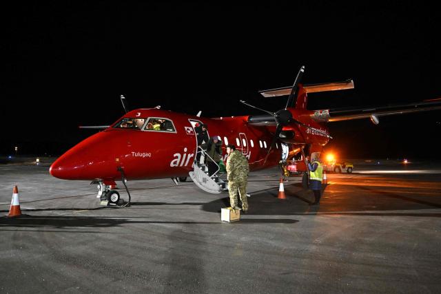 A soldat stands at an aircraft at the airport of Sisimiut, Greenland on January 30, 2026. (Photo by Ina FASSBENDER / AFP)