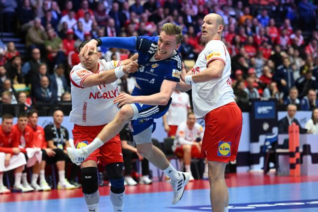 Iceland's centre back #10 Gisli Thorgeir Kristjansson shoots against Denmark's centre back #11 Rasmus Lauge and Denmark's pivot #34 Simon Hald Jensen during the men's EHF Euro 2026 semi-finals handball match Denmark vs Iceland in Herning, Denmark, on January 30, 2026. (Photo by Jonathan Nackstrand / AFP)