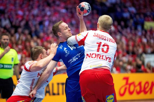 Iceland's Omar Ingi Magnusson (C) fights for the ball with Denmark's Magnus Saugstrup (L) and Thomas Arnoldsen during the men's EHF Euro 2026 semi-finals handball match Denmark vs Iceland in Herning, Denmark, on January 30, 2026. (Photo by Bo Amstrup / Ritzau Scanpix / AFP) / Denmark OUT