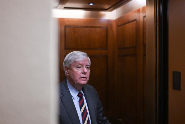 US Senator Lindsey Graham, Republican of South Carolina, speaks to reporters from an elevator at the US Capitol in Washington, DC, on January 30, 2026. US senators began voting on a deal backed by President Donald Trump to avert the worst impact of an imminent government shutdown, after a Republican holdout lifted his block following tense talks. Even if the Senate clears the package, a shutdown is still set to begin on Saturday because the House of Representatives is out of session until Monday, making a brief funding lapse unavoidable. (Photo by Alex WROBLEWSKI / AFP)