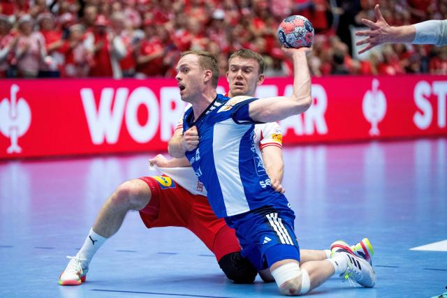 Iceland's Omar Ingi Magnusson (L) shoots against Denmark's Thomas Arnoldsen during the men's EHF Euro 2026 semi-finals handball match Denmark vs Iceland in Herning, Denmark, on January 30, 2026. (Photo by Bo Amstrup / Ritzau Scanpix / AFP) / Denmark OUT