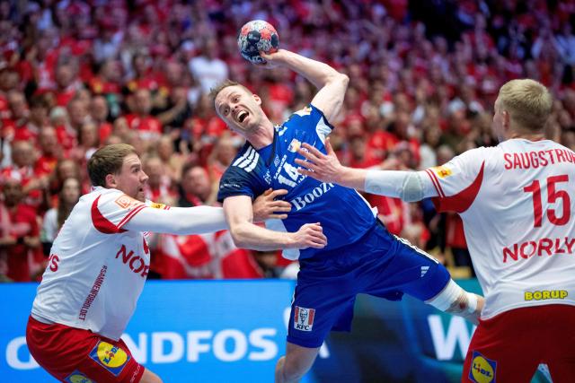 Iceland's Omar Ingi Magnusson (C) shoots against Denmark's Simon Pytlick (L) and Magnus Saugstrup during the men's EHF Euro 2026 semi-finals handball match Denmark vs Iceland in Herning, Denmark, on January 30, 2026. (Photo by Bo Amstrup / Ritzau Scanpix / AFP) / Denmark OUT