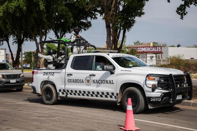 Mexican National Guard officers patrol the streets of Culiacan, Sinaloa state, Mexico on January 30, 2026. Security in the northwestern Mexican state of Sinaloa was reinforced with 1,600 military personnel on January 29, 2026, after two local deputies were shot and ten workers from a Canadian mine were kidnapped. The troops were deployed just as President Claudia Sheinbaum was on the phone with her US counterpart, Donald Trump, to discuss security and trade. (Photo by Jesus VERDUGO / AFP)