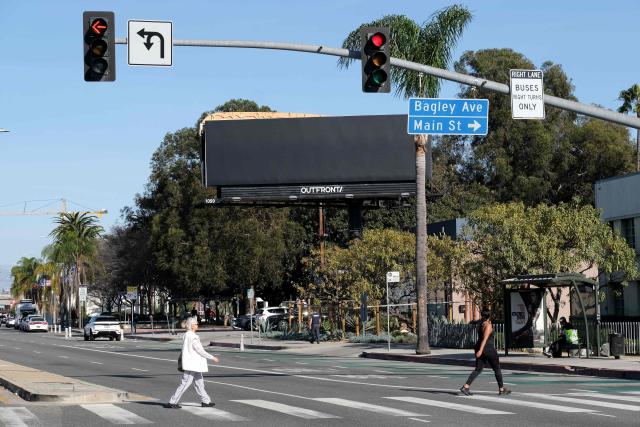 A black covering is placed over a billboard advertising the film “Melania,” allegedly vandalized by the activist art collective INDECLINE, in Culver City, California, on January 30, 2026. (Photo by Chris Delmas / AFP)