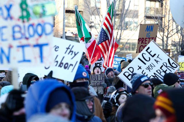 People partake in a "National Shutdown" protest against US Immigration and Customs Enforcement (ICE) in Minneapolis, Minnesota, on January 30, 2026. Donald Trump's border chief said January 29, 2026 that some federal agents could be withdrawn from Minneapolis, the northern US city that has become the flashpoint for the president's immigration crackdown. The Trump administration, facing a public backlash over the shooting deaths of two Americans by federal agents in Minneapolis, also eased immigration operations in the northeastern state of Maine. (Photo by Charly TRIBALLEAU / AFP)