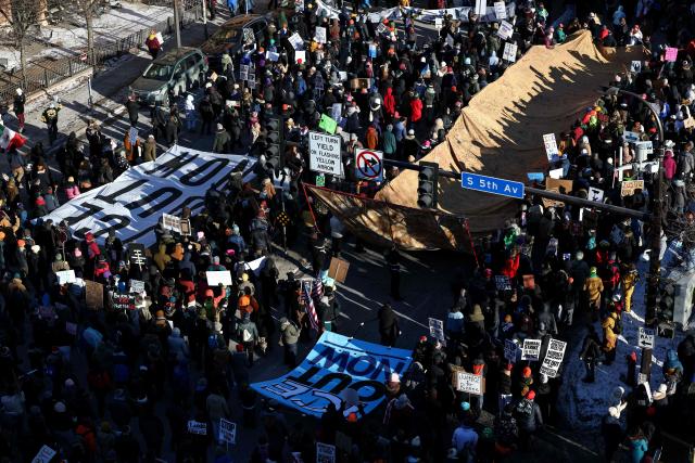 People partake in a "National Shutdown" protest against US Immigration and Customs Enforcement (ICE) in Minneapolis, Minnesota, on January 30, 2026. Donald Trump's border chief said January 29, 2026 that some federal agents could be withdrawn from Minneapolis, the northern US city that has become the flashpoint for the president's immigration crackdown. The Trump administration, facing a public backlash over the shooting deaths of two Americans by federal agents in Minneapolis, also eased immigration operations in the northeastern state of Maine. (Photo by Charly TRIBALLEAU / AFP)