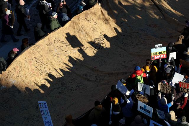 People partake in a "National Shutdown" protest against US Immigration and Customs Enforcement (ICE) in Minneapolis, Minnesota, on January 30, 2026. Donald Trump's border chief said January 29, 2026 that some federal agents could be withdrawn from Minneapolis, the northern US city that has become the flashpoint for the president's immigration crackdown. The Trump administration, facing a public backlash over the shooting deaths of two Americans by federal agents in Minneapolis, also eased immigration operations in the northeastern state of Maine. (Photo by Charly TRIBALLEAU / AFP)
