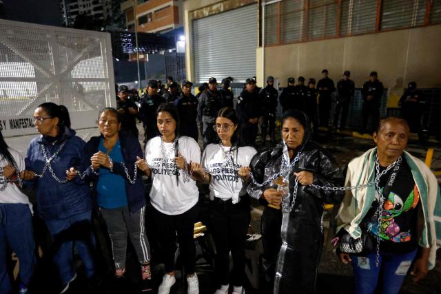 People demonstrate with chains to demand the release of political prisoners outside the Zone 7 prison of the Bolivarian National Police (PNB) in Caracas on January 30, 2026. (Photo by Pedro MATTEY / AFP)