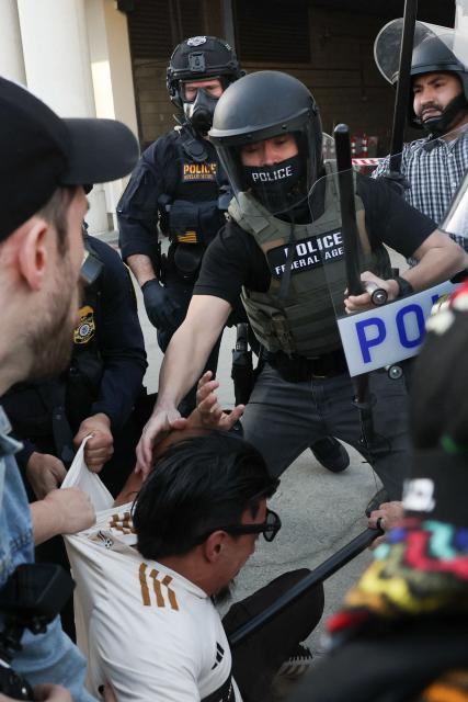 Protestors clash with police during a "National Shutdown" protest against U.S. Immigration and Customs Enforcement in Los Angeles on January 30, 2026. Donald Trump's border chief said January 29, 2026 that some federal agents could be withdrawn from Minneapolis, the northern US city that has become the flashpoint for the president's immigration crackdown. The Trump administration, facing a public backlash over the shooting deaths of two Americans by federal agents in Minneapolis, also eased immigration operations in the northeastern state of Maine. (Photo by Patrick T. Fallon / AFP)