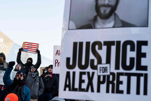People hold a photo of Alex Pretti, who was shot dead by US Immigration and Customs Enforcement (ICE) agents, during a "National Shutdown" protest in Minneapolis, Minnesota, on January 30, 2026. Donald Trump's border chief said January 29, 2026 that some federal agents could be withdrawn from Minneapolis, the northern US city that has become the flashpoint for the president's immigration crackdown. The Trump administration, facing a public backlash over the shooting deaths of two Americans by federal agents in Minneapolis, also eased immigration operations in the northeastern state of Maine. (Photo by ROBERTO SCHMIDT / AFP)