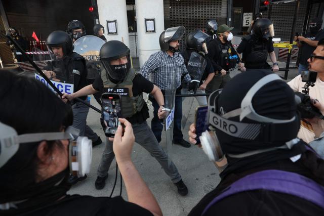 Protestors clash with police during a "National Shutdown" protest against U.S. Immigration and Customs Enforcement in Los Angeles on January 30, 2026. Donald Trump's border chief said January 29, 2026 that some federal agents could be withdrawn from Minneapolis, the northern US city that has become the flashpoint for the president's immigration crackdown. The Trump administration, facing a public backlash over the shooting deaths of two Americans by federal agents in Minneapolis, also eased immigration operations in the northeastern state of Maine. (Photo by Patrick T. Fallon / AFP)