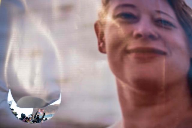 People hold a photo of Renee Good, who was shot dead by US Immigration and Customs Enforcement (ICE) agents, at the end of a "National Shutdown" protest in Minneapolis, Minnesota, on January 30, 2026. Donald Trump's border chief said January 29, 2026 that some federal agents could be withdrawn from Minneapolis, the northern US city that has become the flashpoint for the president's immigration crackdown. The Trump administration, facing a public backlash over the shooting deaths of two Americans by federal agents in Minneapolis, also eased immigration operations in the northeastern state of Maine. (Photo by ROBERTO SCHMIDT / AFP)
