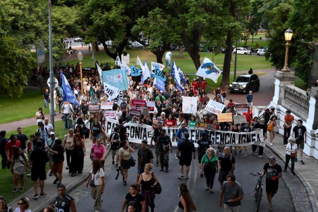 People take part in a protest to demand more help to combat wildfires in Patagonia from Argentina's President Javier Milei government in Buenos Aires on January 30, 2026. Argentina's government on declared an emergency in Patagonia on January 29, 2026, where wildfires have ripped through vast tracts of forest since the start of the Southern Hemisphere summer. (Photo by Luis ROBAYO / AFP)