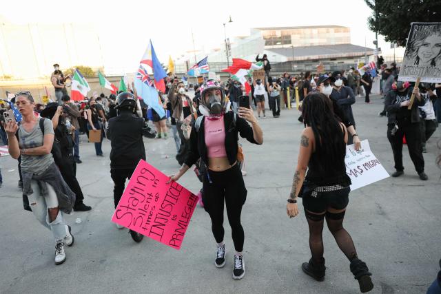 People partake in a "National Shutdown" protest against U.S. Immigration and Customs Enforcement in Los Angeles on January 30, 2026. Donald Trump's border chief said January 29, 2026 that some federal agents could be withdrawn from Minneapolis, the northern US city that has become the flashpoint for the president's immigration crackdown. The Trump administration, facing a public backlash over the shooting deaths of two Americans by federal agents in Minneapolis, also eased immigration operations in the northeastern state of Maine. (Photo by Patrick T. Fallon / AFP)
