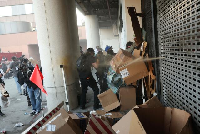 Protestors are sprayed during a "National Shutdown" protest against U.S. Immigration and Customs Enforcement in Los Angeles on January 30, 2026. Donald Trump's border chief said January 29, 2026 that some federal agents could be withdrawn from Minneapolis, the northern US city that has become the flashpoint for the president's immigration crackdown. The Trump administration, facing a public backlash over the shooting deaths of two Americans by federal agents in Minneapolis, also eased immigration operations in the northeastern state of Maine. (Photo by Patrick T. Fallon / AFP)