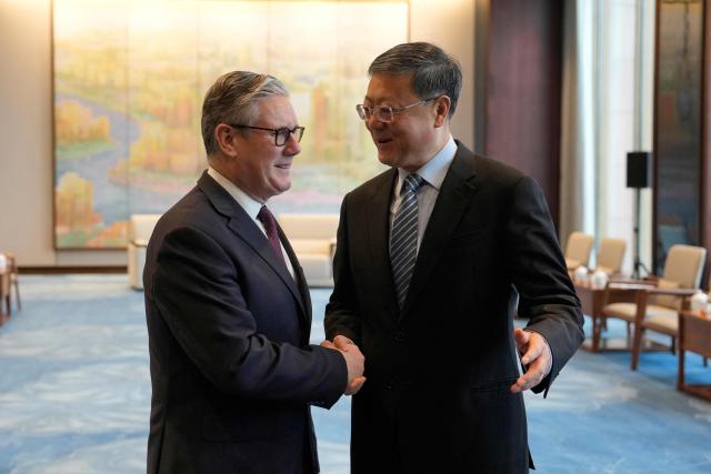 Britain's Prime Minister Keir Starmer (L) shakes hands with Shanghai Party Secretary Chen Jining (R) in Shanghai on January 31, 2026. (Photo by Kin Cheung / POOL / AFP)