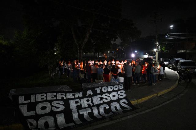 People take part in a vigil to demand the release of political prisoners outside El Rodeo I prison in Guatire, Miranda state, Venezuela on January 30, 2026. Venezelan interim President Delcy Rodriguez announced a "general amnesty" law in Venezuela on January 30, 2026, just days before marking one month since she took power following the overthrow of Nicolas Maduro in a US military incursion. (Photo by Federico PARRA / AFP)