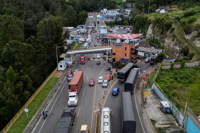 This aerial view shows trucks queueing at the border between Colombia and Ecuador before the new tariff measures imposed by the Ecuadorian government come into effect in Ipiales, Colombia on January 30, 2026. The countries imposed 30% tariffs on each other after Ecuador's President Daniel Noboa accused Colombia of not doing enough to combat drug trafficking along their shared border. The dispute escalated when Colombia suspended electricity sales to Ecuador, and Ecuador raised the tariff for transporting crude oil through its pipeline by 900%. (Photo by Reicarmyr CANIZARES / AFP)