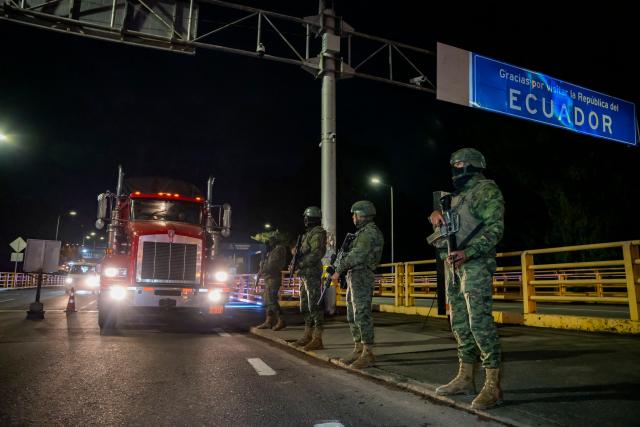 Ecuadorian soldiers guard the entrance of trucks across the border with Colombia before the new tariff measures imposed by the Ecuadorian government coming into effect in Tulcan, Ecuador on January 30, 2026. The countries imposed 30% tariffs on each other after Ecuador's President Daniel Noboa accused Colombia of not doing enough to combat drug trafficking along their shared border. The dispute escalated when Colombia suspended electricity sales to Ecuador, and Ecuador raised the tariff for transporting crude oil through its pipeline by 900%. (Photo by Reicarmyr CANIZARES / AFP)