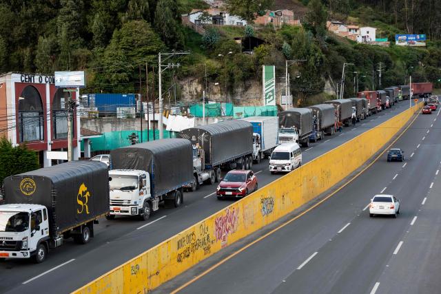 Trucks queue at the border between Colombia and Ecuador before the new tariff measures imposed by the Ecuadorian government come into effect in Ipiales, Colombia on January 30, 2026. The countries imposed 30% tariffs on each other after Ecuador's President Daniel Noboa accused Colombia of not doing enough to combat drug trafficking along their shared border. The dispute escalated when Colombia suspended electricity sales to Ecuador, and Ecuador raised the tariff for transporting crude oil through its pipeline by 900%. (Photo by Reicarmyr CANIZARES / AFP)