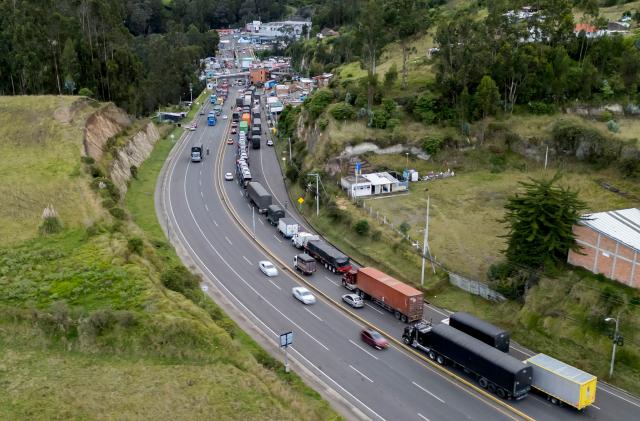 This aerial view shows trucks queueing at the border between Colombia and Ecuador before the new tariff measures imposed by the Ecuadorian government come into effect in Ipiales, Colombia on January 30, 2026. The countries imposed 30% tariffs on each other after Ecuador's President Daniel Noboa accused Colombia of not doing enough to combat drug trafficking along their shared border. The dispute escalated when Colombia suspended electricity sales to Ecuador, and Ecuador raised the tariff for transporting crude oil through its pipeline by 900%. (Photo by Reicarmyr CANIZARES / AFP)
