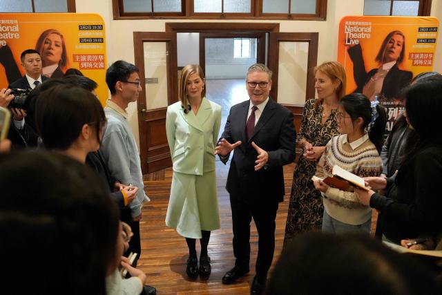 Britain's Prime Minister Keir Starmer and British actor-producer Rosamund Pike meet with Chinese performing arts students at the Design Innovation Institute Shanghai, in Shanghai on January 31, 2026. (Photo by Kin Cheung / POOL / AFP)
