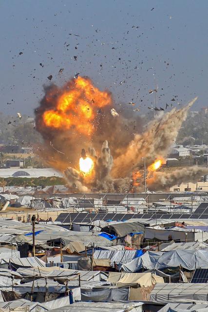 Smoke rises from the Gath shelter, housing displaced Palestinians, after an Israeli air strike in the west of Khan Yunis, southern Gaza Strip on January 31, 2026. Israeli air strikes killed 11 people in the Gaza Strip on January 31, according to the territory's ministry of health, including people sheltering in a tent in the south. (Photo by Bashar Taleb / AFP)