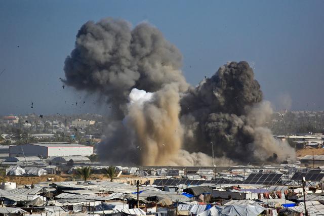 Smoke rises from the Gath shelter, housing displaced Palestinians, after an Israeli air strike in the west of Khan Yunis, southern Gaza Strip on January 31, 2026. Israeli air strikes killed 11 people in the Gaza Strip on January 31, according to the territory's ministry of health, including people sheltering in a tent in the south. (Photo by Bashar Taleb / AFP)