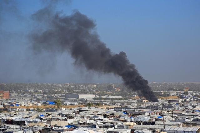 Smoke rises from the Gath shelter, housing displaced Palestinians, after an Israeli air strike in the west of Khan Yunis, southern Gaza Strip on January 31, 2026. Israeli air strikes killed 11 people in the Gaza Strip on January 31, according to the territory's ministry of health, including people sheltering in a tent in the south. (Photo by Bashar Taleb / AFP)
