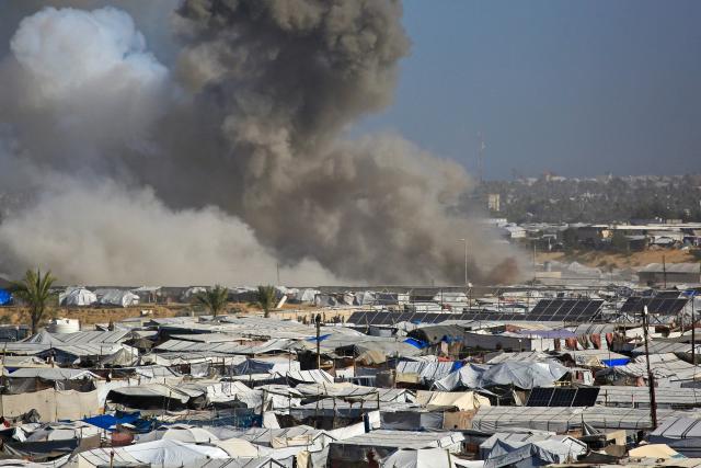 Smoke rises from the Gath shelter, housing displaced Palestinians, after an Israeli air strike in the west of Khan Yunis, southern Gaza Strip on January 31, 2026. Israeli air strikes killed 11 people in the Gaza Strip on January 31, according to the territory's ministry of health, including people sheltering in a tent in the south. (Photo by Bashar Taleb / AFP)