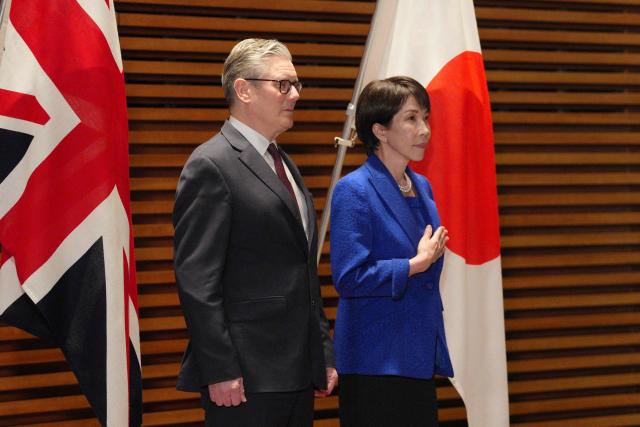 British Prime Minister Keir Starmer attends a ceremonial guard of honour with Japanese Prime Minister Sanae Takaichi at the Prime Minister's Office in Tokyo on January 31, 2026. (Photo by Carl Court / POOL / AFP)