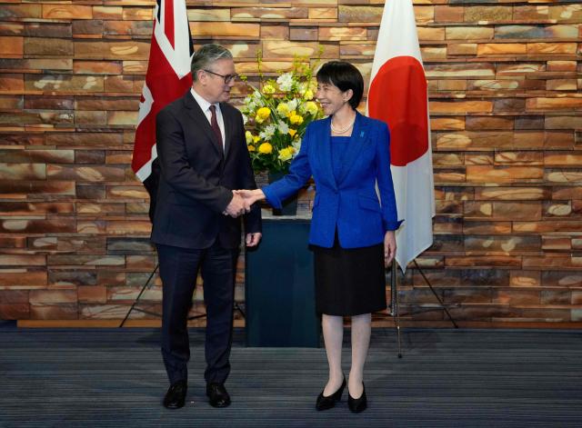 British Prime Minister Keir Starmer shakes hands with Japanese Prime Minister Sanae Takaichi at the Prime Minister's Office in Tokyo on January 31, 2026. (Photo by Kin Cheung / POOL / AFP)