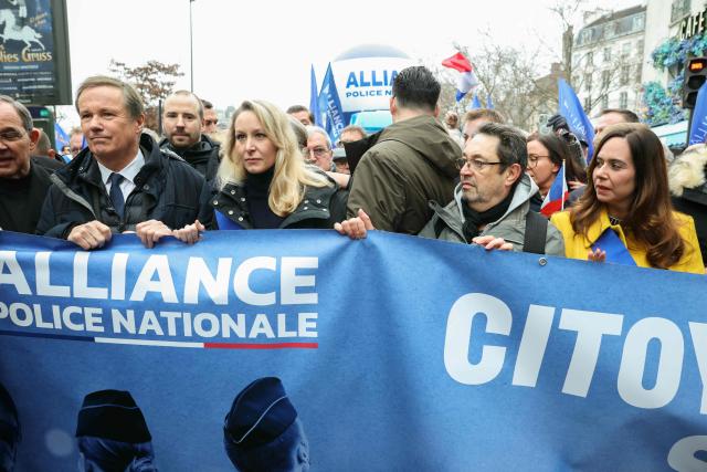 France's far-right party Debout La France (DLF) President Nicolas Dupont-Aignan (2nd-L), right-wing European Conservatives and Reformists (ECR) MEP Marion Marechal (C) and French far-right party Reconquete! MEP and candidate for mayor of Paris Sarah Knafo (R) take part in a demonstration called by the union Alliance Police Nationale to denounce the lack of ressources in their corporation in Paris on January 31, 2026. (Photo by Alain JOCARD / AFP)