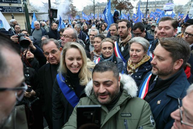 Right-wing European Conservatives and Reformists (ECR) MEP Marion Marechal (C) poses for a selfie photograph with a supporter next to Rassemblement National's MP Thibaut Monnier (R) while taking part in a demonstration called by the union Alliance to denounce the lack of ressources in their corporation in Paris on January 31, 2026. (Photo by Alain JOCARD / AFP)