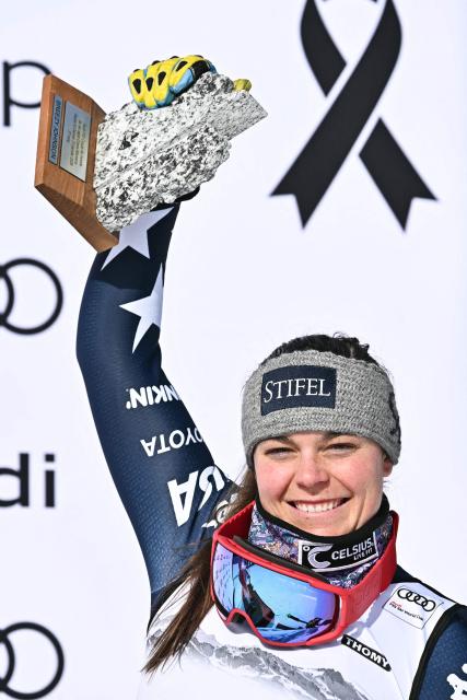 Third-placed US Breezy Johnson celebrates on the podium after competing in the women's super G race part of the FIS Alpine Ski World Cup 2025-2026, in Crans Montana, Switzerland, on January 31, 2026. (Photo by Fabrice COFFRINI / AFP)