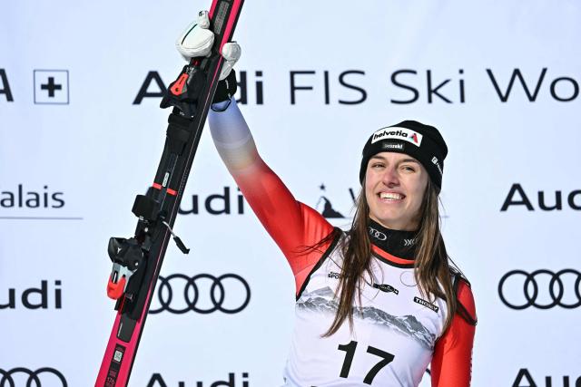 First-placed Switzerland's Malorie Blanc celebrates on the podium after competing in the women's super G race part of the FIS Alpine Ski World Cup 2025-2026, in Crans Montana, Switzerland, on January 31, 2026. (Photo by Fabrice COFFRINI / AFP)