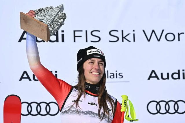 First-placed Switzerland's Malorie Blanc celebrates on the podium after competing in the women's super G race part of the FIS Alpine Ski World Cup 2025-2026, in Crans Montana, Switzerland, on January 31, 2026. (Photo by Fabrice COFFRINI / AFP)