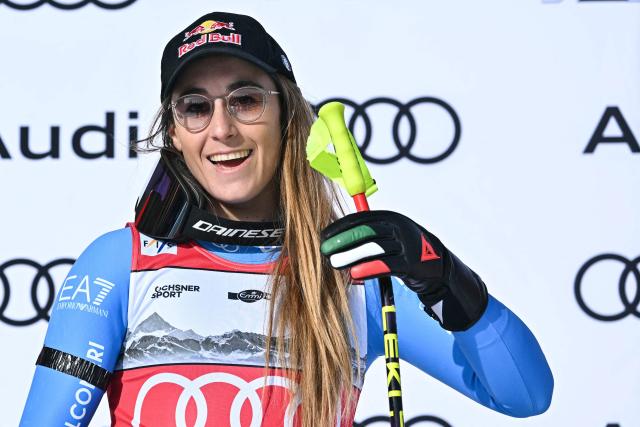 Second-placed Italy's Sofia Goggia celebrates on the podium after competing in the women's super G race part of the FIS Alpine Ski World Cup 2025-2026, in Crans Montana, Switzerland, on January 31, 2026. (Photo by Fabrice COFFRINI / AFP)