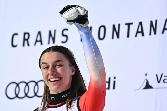 First-placed Switzerland's Malorie Blanc celebrates on the podium after competing in the women's super G race part of the FIS Alpine Ski World Cup 2025-2026, in Crans Montana, Switzerland, on January 31, 2026. (Photo by Fabrice COFFRINI / AFP)