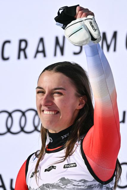 First-placed Switzerland's Malorie Blanc celebrates on the podium after competing in the women's super G race part of the FIS Alpine Ski World Cup 2025-2026, in Crans Montana, Switzerland, on January 31, 2026. (Photo by Fabrice COFFRINI / AFP)