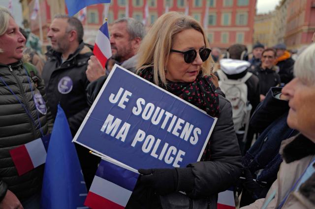 A woman holds a placard reading “I support my police” as she takes part in a demonstration called by the Alliance Police Nationale union to denounce the lack of resources in their profession in Nice, south-eastern France, on January 31, 2026. (Photo by Valery HACHE / AFP)