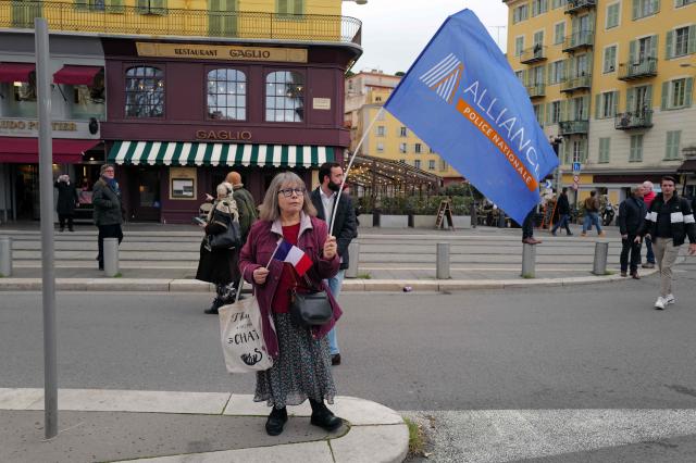 A woman waves an Alliance union flag during a demonstration called by the Alliance Police Nationale union to denounce the lack of resources in their profession in Nice, south-eastern France, on January 31, 2026. (Photo by Valery HACHE / AFP)