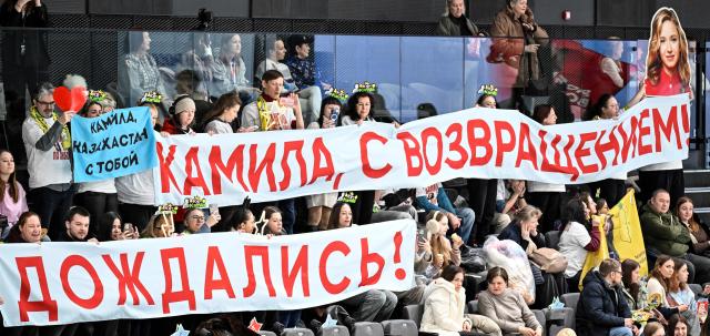 Fans of Russia's figure skater Kamila Valieva show their support by holding up a banner reading "Welcome Back Kamila! We've finally waited!" during Russia's Skate Jumping Championship at Navka arena in Moscow on January 31, 2026. Russian figure skating prodigy Kamila Valieva returns to competitive sport on Saturday hoping to roll back the years in a once promising career blighted by a doping scandal. Aged just 15 years she had propelled Russia to team gold at the 2022 Winter Games in Beijing, becoming the first female skater to land a quadruple jump in an Olympic competition, but that medal and all her other titles from December 2021 onwards were stripped after it emerged she had failed a doping test before the Winter Olympics, a decision the Kremlin denounced as "politicised". (Photo by Alexander NEMENOV / AFP)