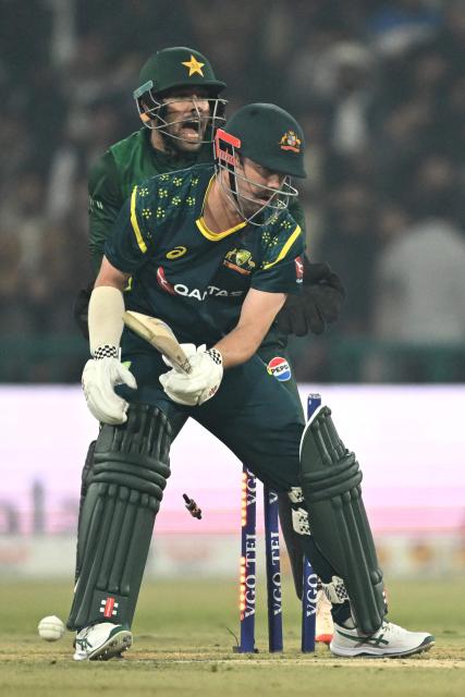 Australia's Travis Head is clean bowled by Pakistan's Saim Ayub during the second Twenty20 international cricket match between Pakistan and Australia at the Gaddafi Cricket Stadiu in Lahore on January 31, 2026. (Photo by Arif ALI / AFP)