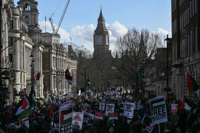 Protesters hold placards and wave Palestinian flags during a march organised by the Palestine Solidarity Campaign in central London on January 31, 2026.  (Photo by JUSTIN TALLIS / AFP)