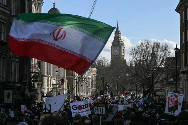 Protesters hold placards and wave Palestinian flags during a march organised by the Palestine Solidarity Campaign in central London on January 31, 2026.  (Photo by JUSTIN TALLIS / AFP)